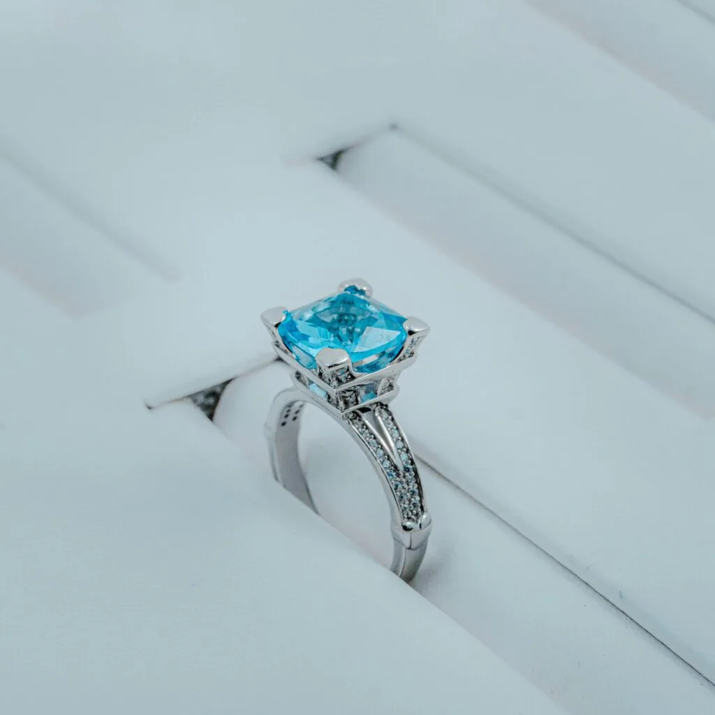 An exquisite silver ring featuring a striking blue gemstone, perfect for weddings or special occasions.